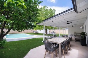 Enjoy sunshine or shade with multiple patios in this large backyard space.