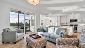 Living room overlooking the lanai and golf course