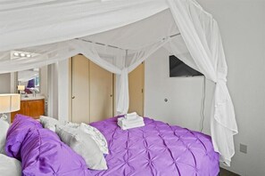 Queen bed with view of TV in the bedroom