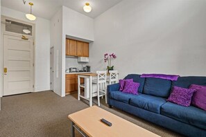 Living room view with hightop kitchen seating