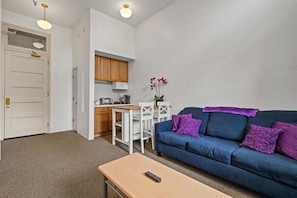 Living room view with hightop kitchen seating