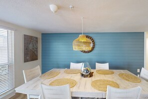 Spacious family area for indoor seating and dining.  Beautiful shiplap accent wall for a beachy guest experience.