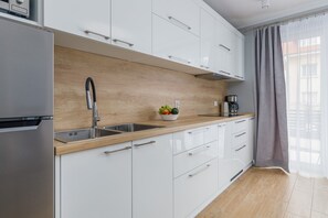 A sleek, fully equipped kitchen with wooden countertops, plenty of cabinet space, and contemporary appliances.
