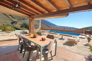 The summer kitchen overlooking the pool.