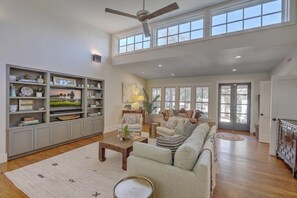 Bright and airy living room with high ceilings and modern design.