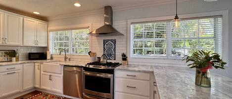 Kitchen is very spacious with tons of counter space and bar seating for 4 guests