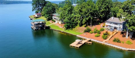 Beautiful deep water cove home is behind no wake zone with big water nearby. 