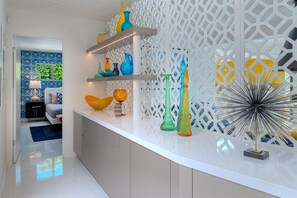 Foyer entry with collection of vintage glass.  