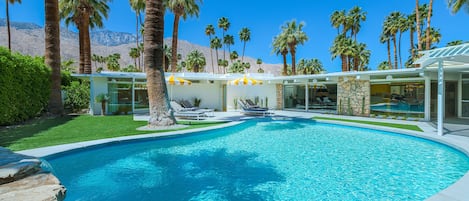 Kidney bean-shaped pool in spacious yard with heaters, misting machines, views. 