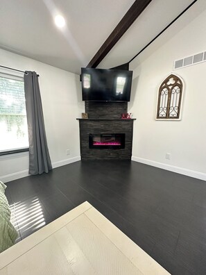 Gas Fireplace in Living Room with Large Smart TV.