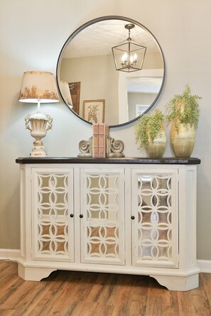 Beautiful 3 door mirrored sideboard in the foyer.