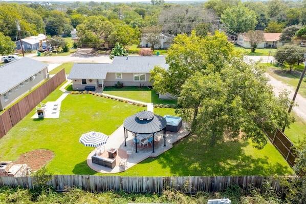 Huge backyard to entertain! Spa, covered & lighted dining area, fire pit, propane BBQ grill. There are lights under the gazebo and around the pathways & a few flood lights in the back yard. Table / desk / workspace / outdoor office with fast WIFI