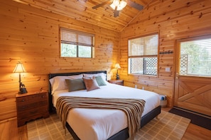The bedroom has new king size bed and a door to the back deck with hot tub.