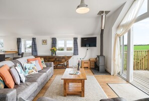 Hayloft at Trevissick Farm, Porthtowan. Relax on the large sofas and watch some television