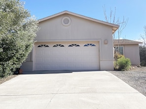 Front of house, private driveway to room is at right