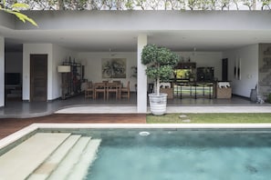 Outdoor dining and kitchen overlook the pool