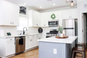 Experience the charm of a beautifully renovated open-plan kitchen with a light and airy ambiance.