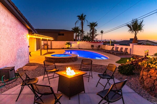 an expansive yard with a sparkling heated pool, SPA, BBQ grill, fire pit.