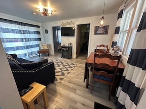 Dining area/living room. The dining table has a drop leaf you can put up.