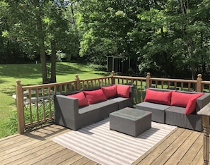Back deck area for outdoor relaxation. Private, surrounded by trees.