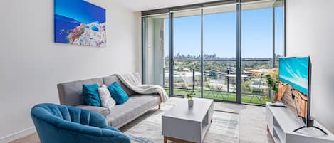 Unwind in style with breathtaking city views from your chic living room—a perfect blend of serenity and sophistication