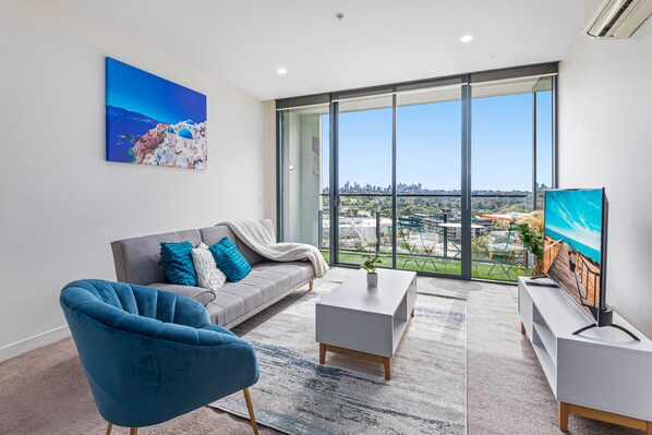 Unwind in style with breathtaking city views from your chic living room—a perfect blend of serenity and sophistication