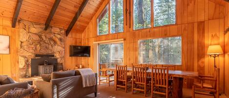 Cozy living area with view of the trees, dining for eight and wo