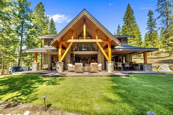 Grand Timber Entry Framed By Dramatic Peaks And Vaulted Glass Façade