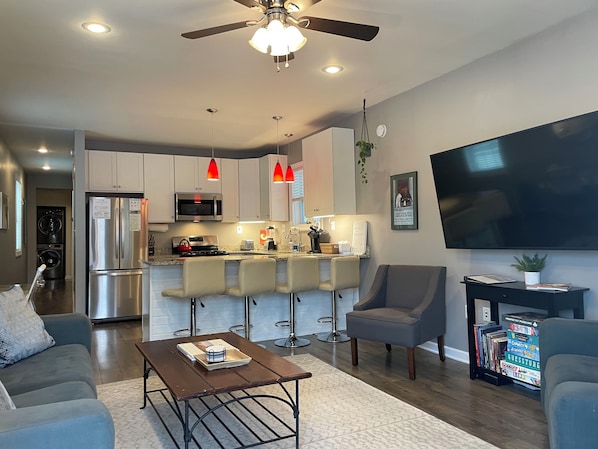 Open floor plan living room and kitchen with 65" TV