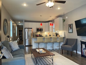 Living room open to eat-at kitchen counter with 4 adjustable stools