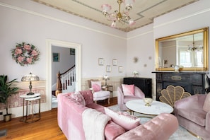Living Room off entry. 1887 original fireplace and flooring.