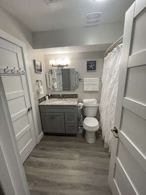 Shared downstairs bathroom with tub and shower