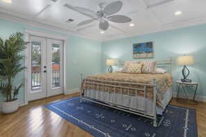 Bedroom 1 - King sized bed with Smart TV and door to back deck/backyard