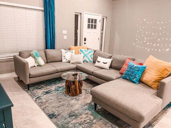 Lounge in style: comfy sectional, bold decor, and space to stream, snack, or reconnect—your chill zone awaits