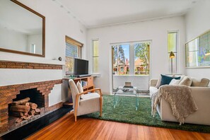 LIVING ROOM: Sunny, spacious Living Room has a double sofa bed couch.