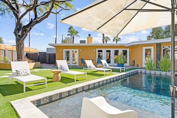 Beautiful sparkling pool and resort style backyard welcome you to