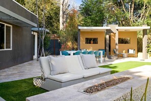 The pool boasts a water feature and built in propane firepit