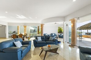 Expansive living room with large glass doors, coastal breezes and amazing views
