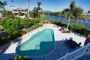 Private pool with outdoor dining table and sun loungers
