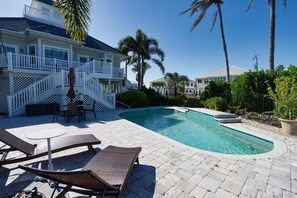 Private pool with outdoor dining table and sun loungers