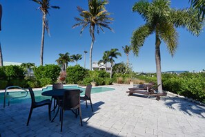 Private pool with outdoor dining table and sun loungers
