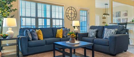 Warm and inviting living room with 65-inch TV.