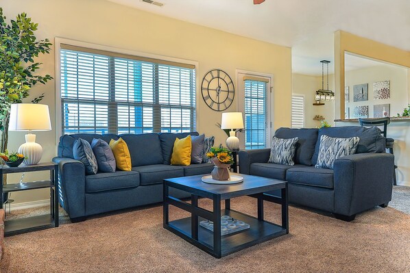 Warm and inviting living room with 65-inch TV.