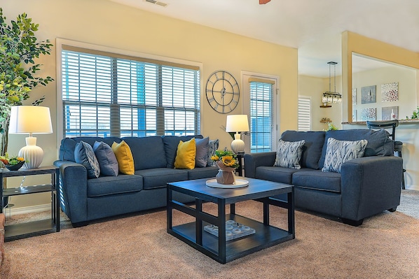 Warm and inviting living room with 65-inch TV.