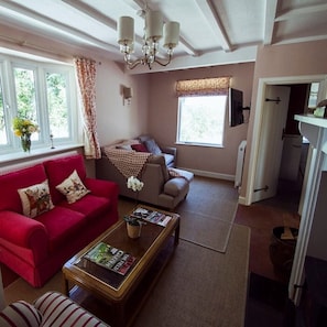 The sitting room with a wood burning and large tv for cosy movie nights