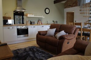 Lounge with dining area at Warren Barn, Newlands Farm near Kirkby Malzeard in Nidderdale AONB