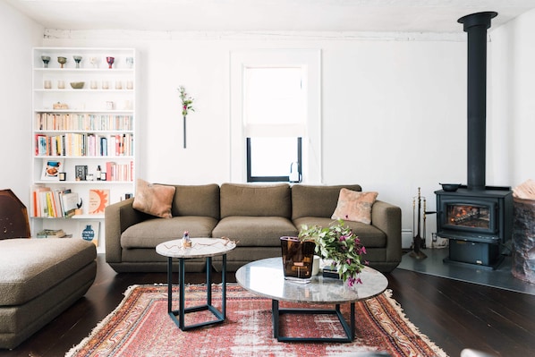 At the heart of Hart House is the living room, outfitted with a cozy wood stove.