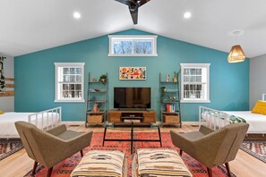 Kids haven upstairs featuring 4 twin beds and 55" TV.