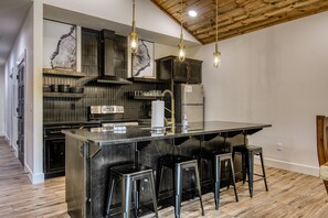 Kitchen with stainless steel appliances and bar seating for 4