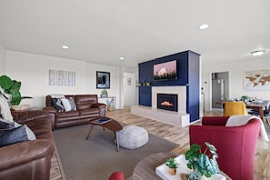 A spacious living area invite families to gather and create lasting memories together. The open layout provides ample space for shared activities and lively board game sessions.